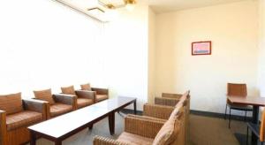 a waiting room with couches and a table and chairs at Shirako New Seaside Hotel in Shirako +55 photos