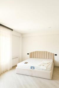 a bedroom with a large white bed in a room at RR Boutique Hotel in Yerevan