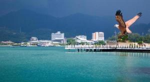 a statue of an eagle on a pier next to the water at Mawanza Hotel Langkawi in Langkawi Islands