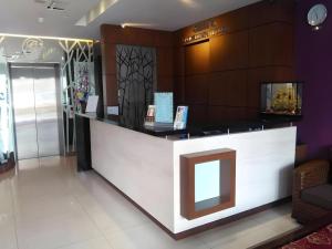 a lobby of a store with a reception counter at Grand Medallion Hotel in Kampong Tabuan