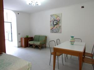 - un salon avec une table à manger et des chaises dans l'établissement Flora, à Atrani