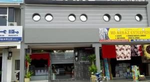 a building with a sign on the side of it at Pendang Suite Hotel PLT in Pendang