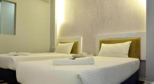 Postel nebo postele na pokoji v ubytování First Residence Hotel Kemaman + 3 fotografie