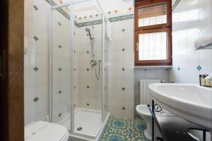 a bathroom with a shower and a toilet and a sink at VeronaInFlat - Castle View in Verona