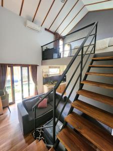 a living room with a staircase in a house at Nana's Villa Sanur in Sanur +27 photos