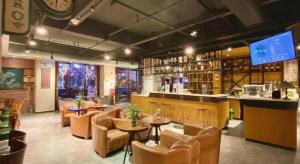 a restaurant with a bar and tables and chairs at James Joyce Coffetel Xian Big Goose Pagoda Tang Paradise Branch in Xi'an