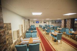 a dining room with blue chairs and tables at Royal İnci Hotel in Istanbul