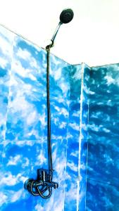 a light on a wall with a blue sky at Lotus View Home in Nuwara Eliya