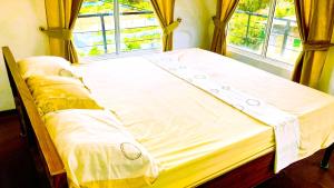 a large bed in a room with a window at Lotus View Home in Nuwara Eliya +22 photos