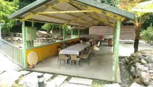 a restaurant with a table and chairs under a roof at Seasons Inn in Jiaoxi