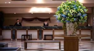 a large vase of flowers on a table in a room at Air Terminal Hotel in Chitose