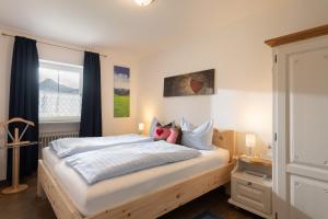 ein Schlafzimmer mit großem Bett und Fenster in der Unterkunft Bergschlössl Whg 10 in Oberaudorf