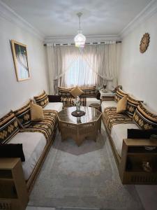 a living room with two beds and a coffee table at Nice apartment by the beach in Sale