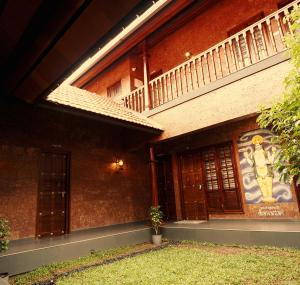 a building with a mural on the side of it at Punarjeevani Ayurvedic Heritage in Vythiri