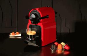 a red coffee maker with a glass on a table at Nice apartment by the beach in Sale +5 photos