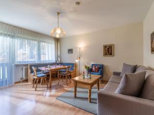 a living room with a couch and a table at Ferienwohnanlage Oberaudorf D 2 mit Hallenbad und Sauna in Oberaudorf