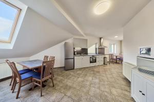 a kitchen and dining room with a table and chairs at Garnet Penzion in Olomouc