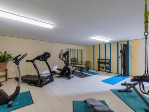 ein Fitnessstudio mit mehreren Laufbändern und Ergometern in der Unterkunft Ferienwohnanlage Oberaudorf E5 mit Hallenbad und Sauna in Oberaudorf
