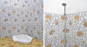 a bathroom with a toilet and a tiled wall at SPOT ON 91993 Pondok Hs Padalarang Syariah in Simpar