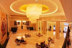 a lobby with people sitting in chairs in a building at Chutian Guangdong International Hotel in Wuhan +221 photos