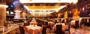 a banquet hall with tables and chairs in a building at Chutian Guangdong International Hotel in Wuhan