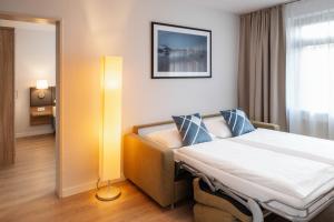 Ένα ή περισσότερα κρεβάτια σε δωμάτιο στο GHOTEL hotel & living Hannover