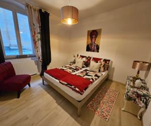 a bedroom with a bed and a couch and a window at Art House Olymp in Bamberg +71 photos