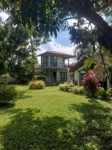 a house with a lawn in front of it at Yala Hideaway in Tissamaharama