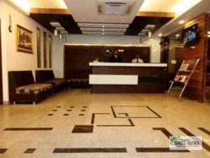 a lobby with a bar and a person in a room at Hotel Shree Vatika in Bhopal