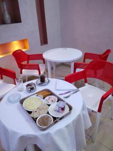 a plate of food on a table with red chairs at Centro Citta Hotel in Cairo