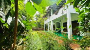 a house with a garden in front of it at The Secret Garden Sigiriya in Sigiriya