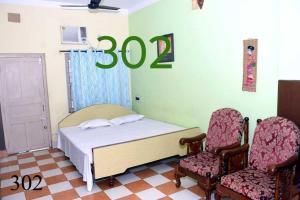 Ένα ή περισσότερα κρεβάτια σε δωμάτιο στο TAKI Suhasini Guest House +10 φωτογραφίες