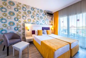 a hotel room with a bed and a chair at Ramada Resort Side in Side