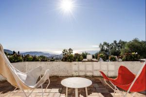 a group of chairs and a table on a patio at Villa, piscine et vue mer exceptionnelle à Nice in Nice +68 photos