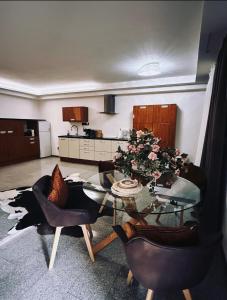 a living room with a glass table and chairs at Koliba 222 in Bratislava +4 photos