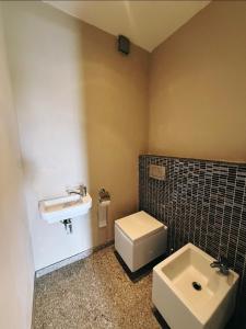 a bathroom with a white toilet and a sink at Koliba 222 in Bratislava