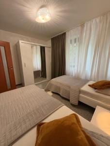 a hotel room with two beds and a window at Koliba 222 in Bratislava