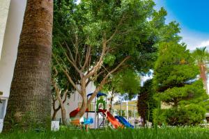 a playground in a park with trees and grass at SOLANA By YELKEN in Turgutreis