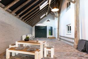 a room with a table and chairs and a building at Gulfhof Fresena in Norden