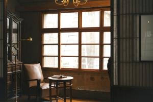 a room with a window and a table and a chair at FunNan Guesthouse in Tainan