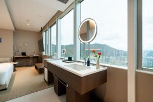 a bathroom with a sink and a large window at Calmsea Hotel in Shenzhen