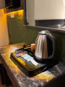 a tea kettle on a tray on a counter at Hotel Güleryüz 2 in Antalya