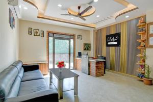 a living room with a couch and a table at Collection O Asian Highway Near Agrasen Hospital Siliguri Formerly Ashiyana Homestay in Binnāguri