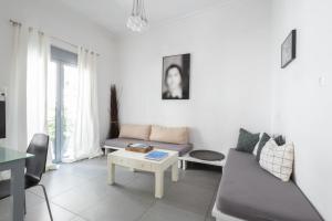 a living room with a couch and a table at Renovated 4 Bdr House near Acropolis - New Beds, Terrace & Green Yard in Athens
