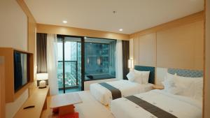 a hotel room with two beds and a window at Lynntimes Thanh Thủy Wellness Hotel & Resort in La Phu +56 photos