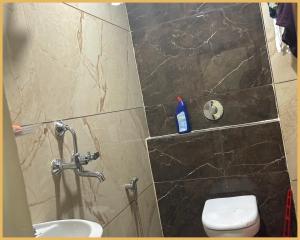 a bathroom with a toilet and a sink at Hotel Shree- Nidhi Premium comfort # Stay Near Mahakaleshwar Jyotirlinga # Railway Station # Free Wi-Fi And Parking Service - Best Hotel In Ujjain in Ujjain