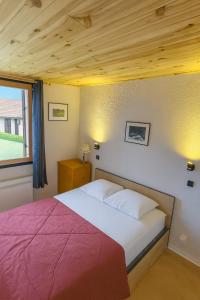 a bedroom with a bed with a red blanket at Le Bois Joli en Chartreuse in Saint-Pierre-de-Chartreuse +14 photos