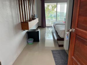 a room with a bed and a door to a bedroom at Phulanta Resort in Ko Lanta Yai +53 photos