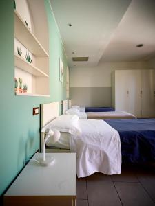 a room with two beds and a table at L'Archetto in Cremona +33 photos