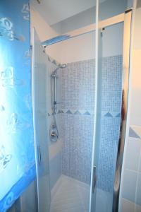 a bathroom with a shower with a glass door at Parco Carrara in Crotone